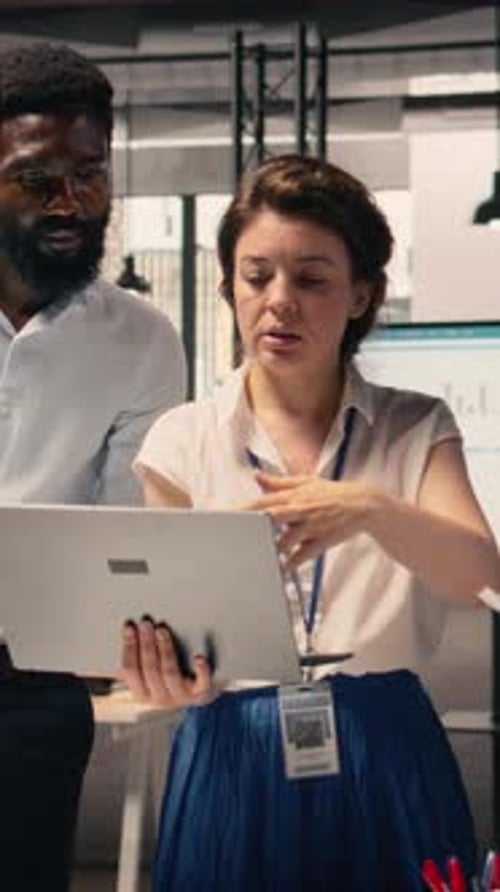 Vertical Video Diverse Work Team Reviewing Business Intelligence Reports and Forecasting Data