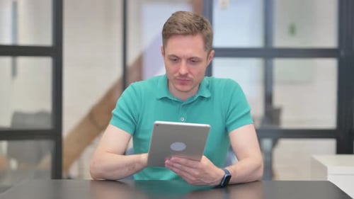 Man Using Tablet Celebrating Good News