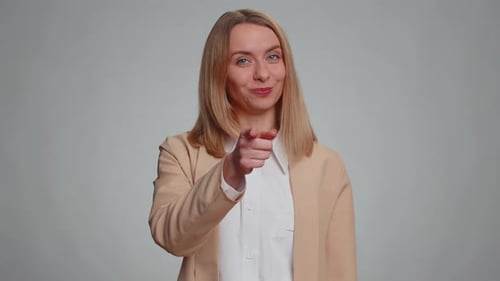 Woman Pointing to Camera and Looking with Playful Happy Expression Making Choice Showing Direction