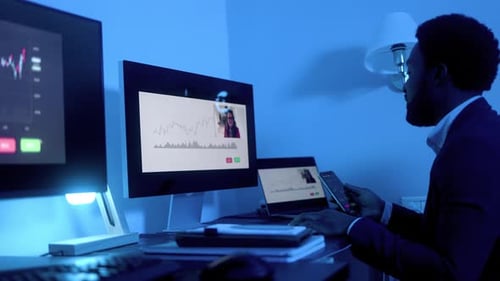 Business African trader investor making stock market analysis video call inside office at night