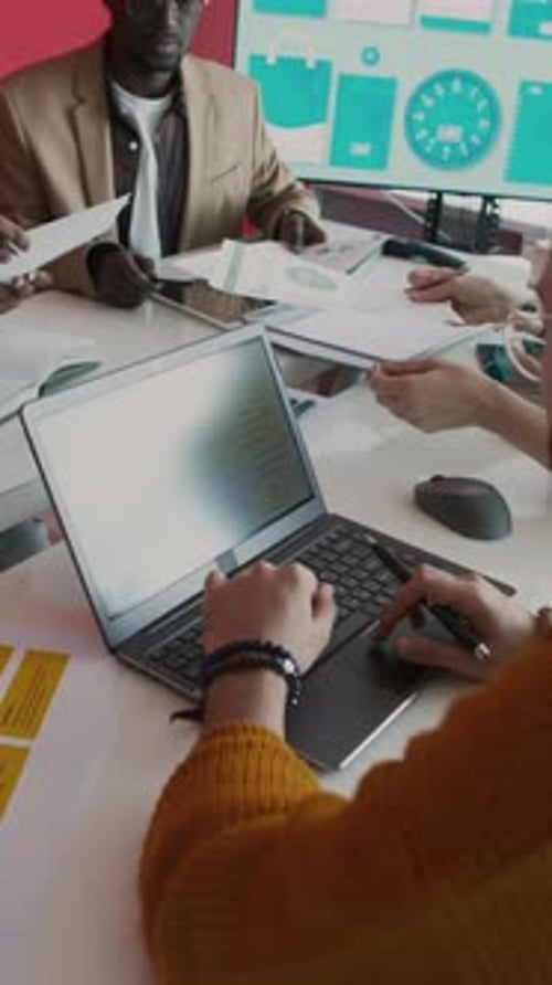Multiethnic Team Working on Presentation at Meeting in Office