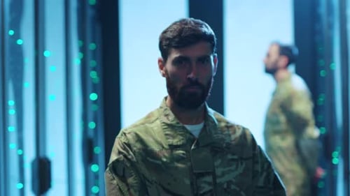 Soldier in Military Uniform Stands in Server Room