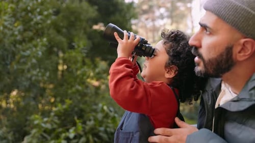 Child and Adult Looking Through Binoculars Outdoors