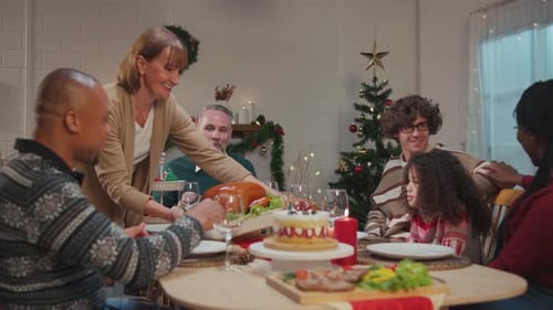 Family Celebrates Christmas Dinner Together at Home