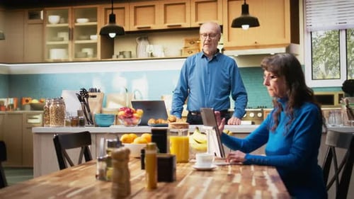 Senior Couple in Kitchen with Breakfast and Technology
