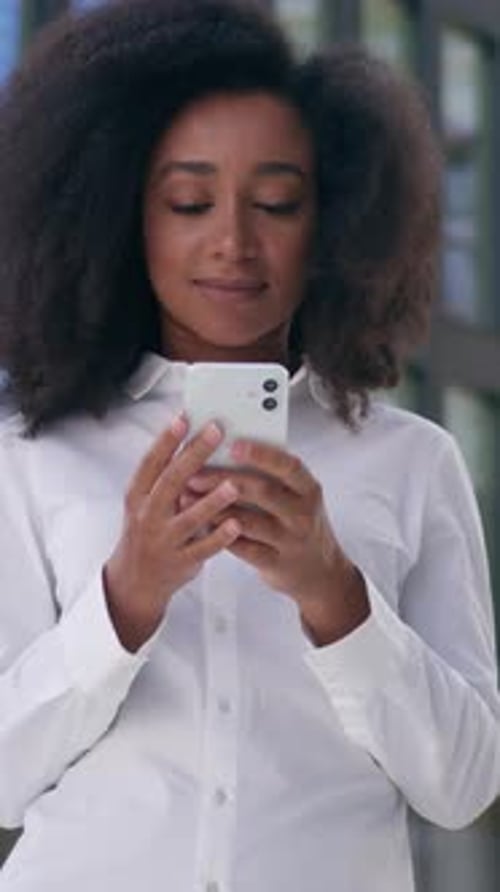 Smiling African American Business Woman Typing Mobile Phone Using Smartphone Outdoors in City Female