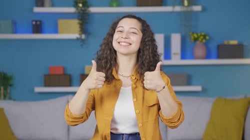 Smiling Woman Gives Thumbs Up in Living Room