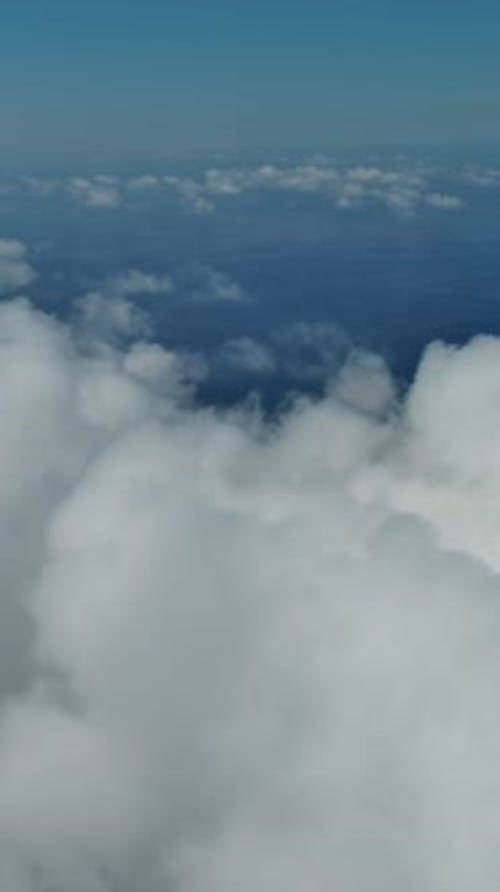 Flying through white clouds over sea