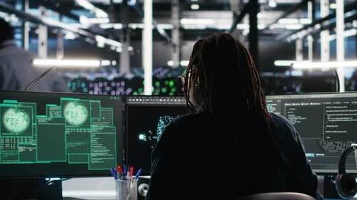 Programmer Works at Multiple Monitors in Futuristic Office