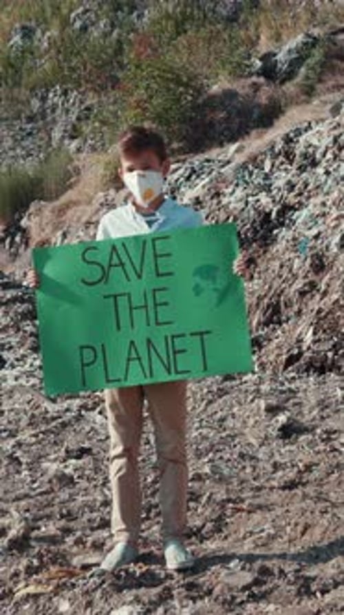 Young Boy Stands With Sign, Save the Planet