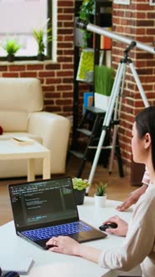 Vertical Video Diverse Software Developers Team Coding on a Laptop in a Cozy Home Office