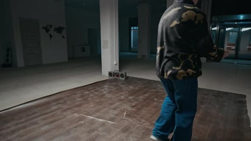Man Dancing in Empty Room with Radio