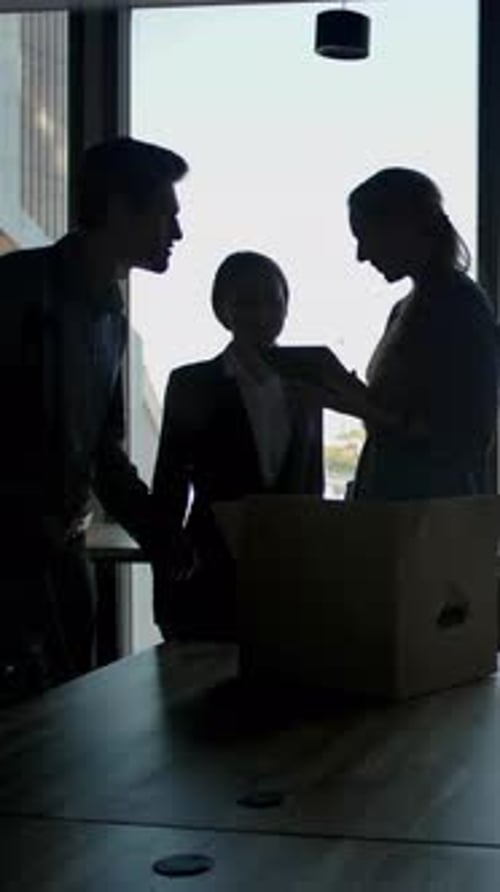 Vertical of Several Silhouettes of Attractive Handsome Businesspeople Interacting Business Center