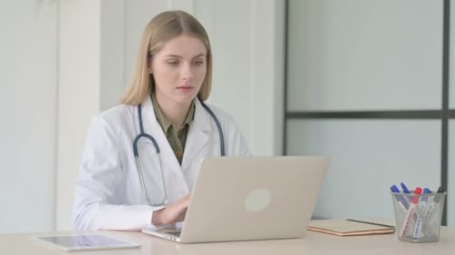 Lady Doctor Looking at Camera at Work in Clinic