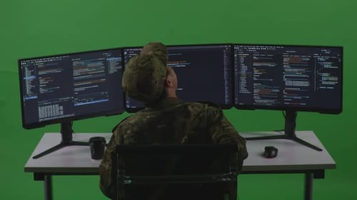 Asian Man Soldier Developer Having Backache While Write Code With Multiple Screens In Green Screen