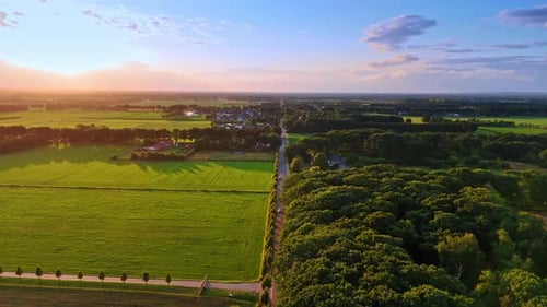 Sunlit meadows and lush forests. Spectacular scenery of picturesque countryside at sunset.