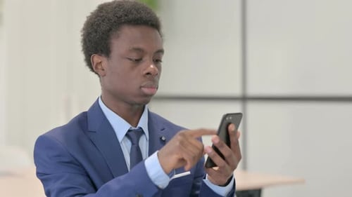 Young Adult Businessman in Suit Using Mobile Phone