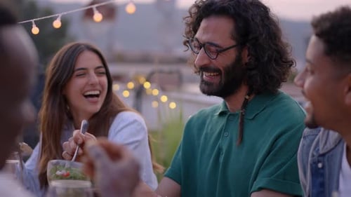 Friends Laughing During an Outdoor Dinner Party
