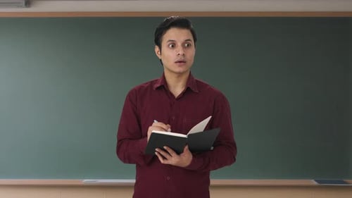 Indian teacher taking attendance in class