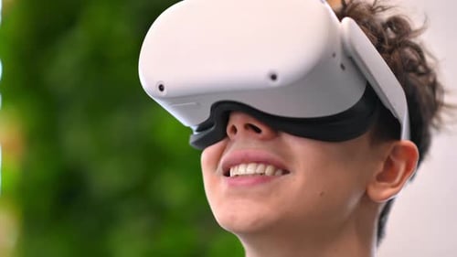 A young excited caucasian man exploring virtual reality using VR glasses in an office