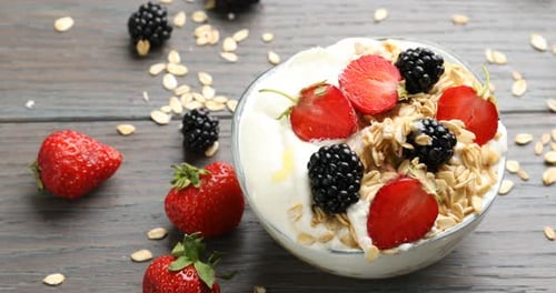 Healthy Yogurt with Berries and Honey on Wooden Table