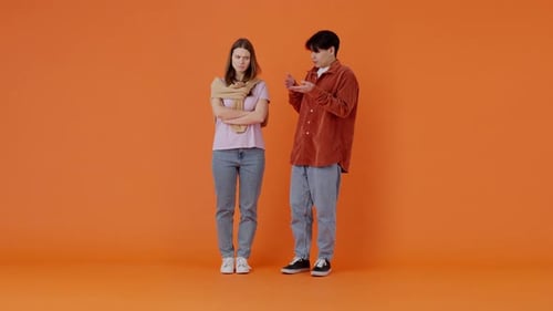 Asian Man Yells at Upset European Woman in Orange Premise