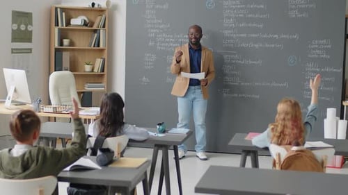 Profesor masculino que hace preguntas a los estudiantes