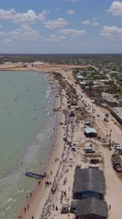 Aerial Vertical Video of Busy Manaure Beach, La Guajira, Colombia Coastline for Social Media