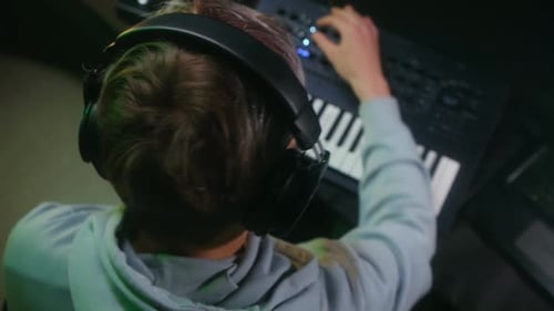 Musician Composing Music on Keyboard in Studio