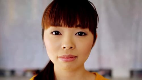 Smiling young woman close up portrait looking at camera