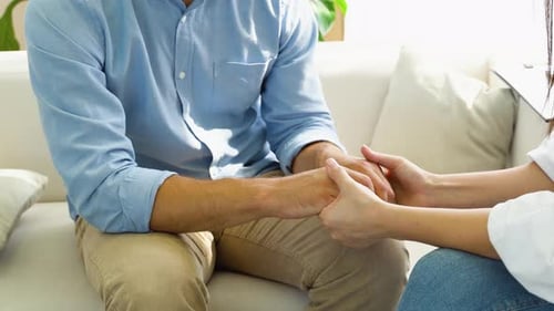 Male Patient in the Consultation of a Female Psychiatrist Mental Health Holding Hands Close Up