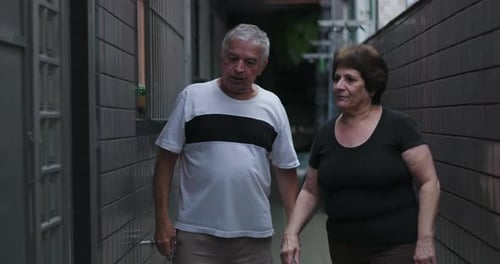 Older Man and Woman Arguing Outdoors in Alleyway