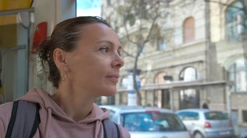 Pensive Traveler in Urban Tramway