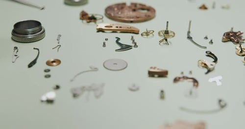 Watch Components Disassembled and Spread Out on Table