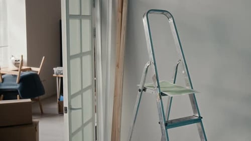 Indoor Space Featuring Step Ladder near White Wall with Open Glass Panel Doors