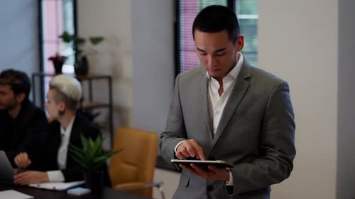 Asian Successful Businessman on Teambuilding Young Man Office Worker Using Tablet in Front of Team