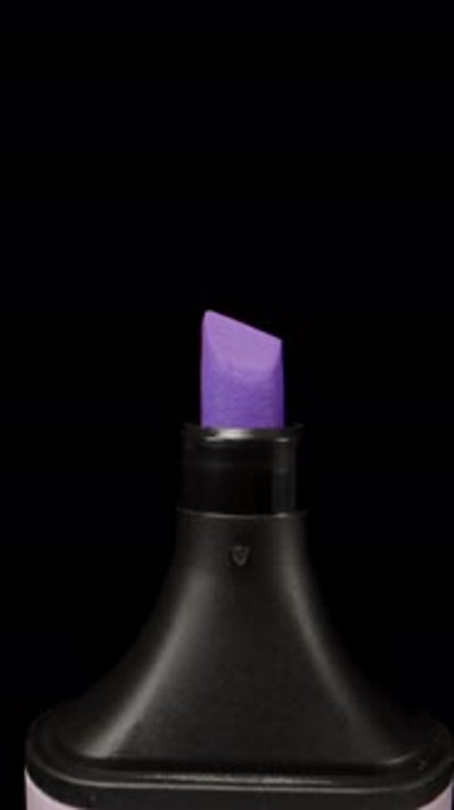 Violet marker on a black background, magnification. Dolly slider extreme close-up. Laowa Probe Verti