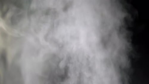 Rising White Smoke Against Black Background
