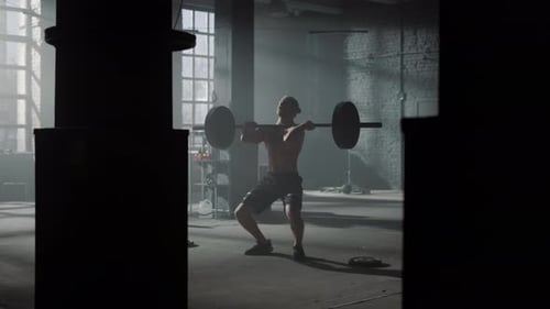 Male Powerlifter Doing Weightlifting Exercise in Fitness Gym. Strong Man with Naked
