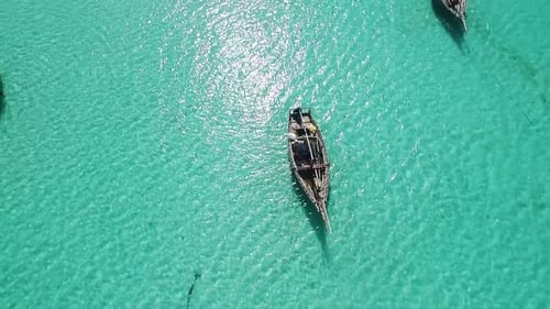 Traditional Boat Sailing in Tropical Turquoise Water