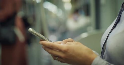 Woman Using Smartphone in Urban Public Transport