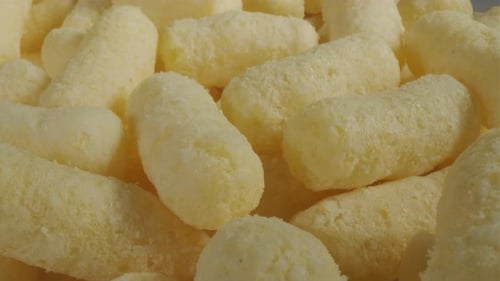 Close Up of Yellow Air Corn Sticks Closeup Crunchy Corn Snacks Texture Selective Focus
