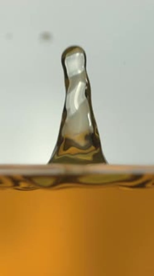 Amber Liquid Droplet Splashing in Slow Motion