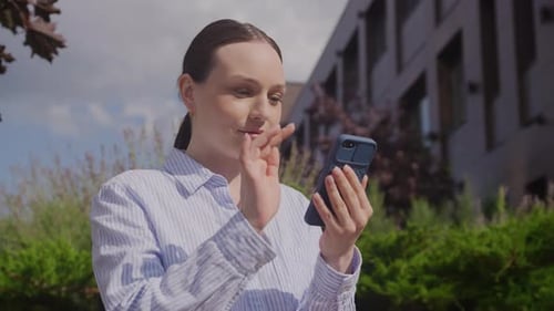 Young Woman Using Mobile Phone Outside