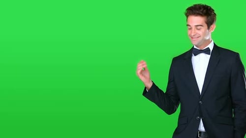 Man, suit and green screen with hand presentation, mockup space and luxury fashion