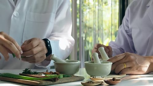 The scientist or doctor make herbal medicine from herb in the laboratory on the table. Herb medicine