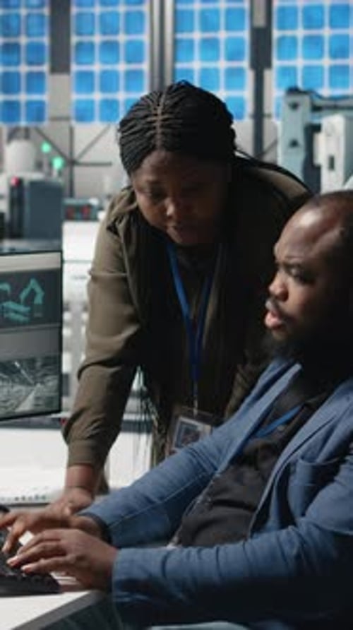Vertical Video African American Factory Experts Engaging in Manufacturing Process Analysis
