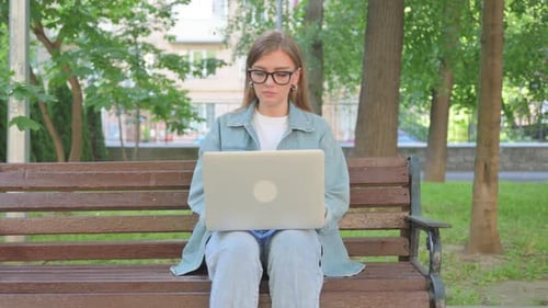 Young Woman Works on Laptop in Green Park
