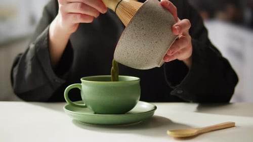 Matcha Green Tea Cooking Process Japanese Powder Green Tea in a Bowl with Bamboo Whisk Macro Close