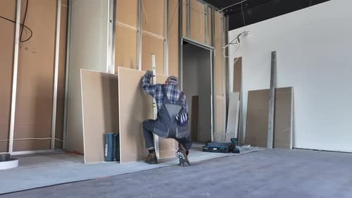 Construction Worker Measuring Building Materials